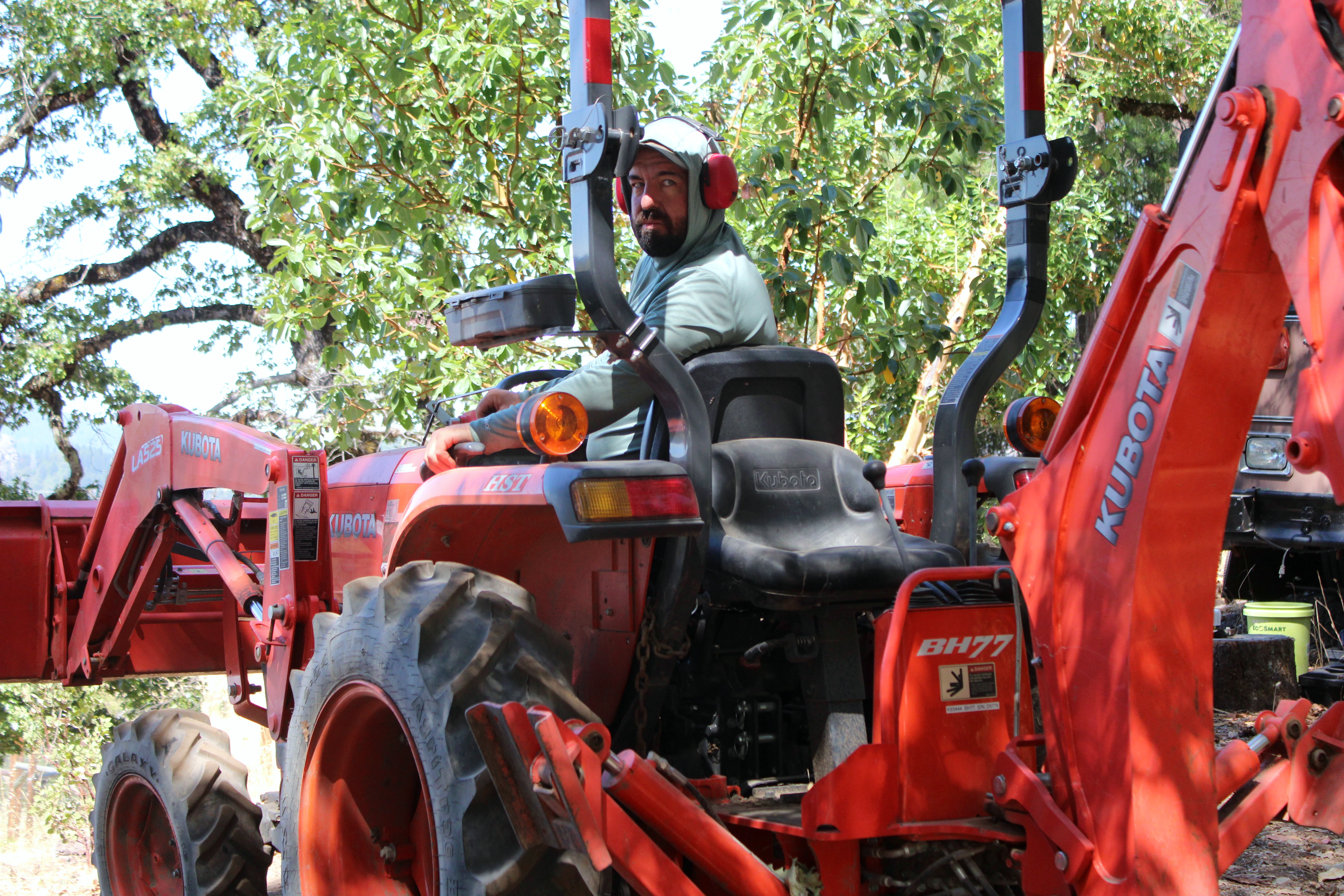 Farmer operating a tractor at HappyDay Farms